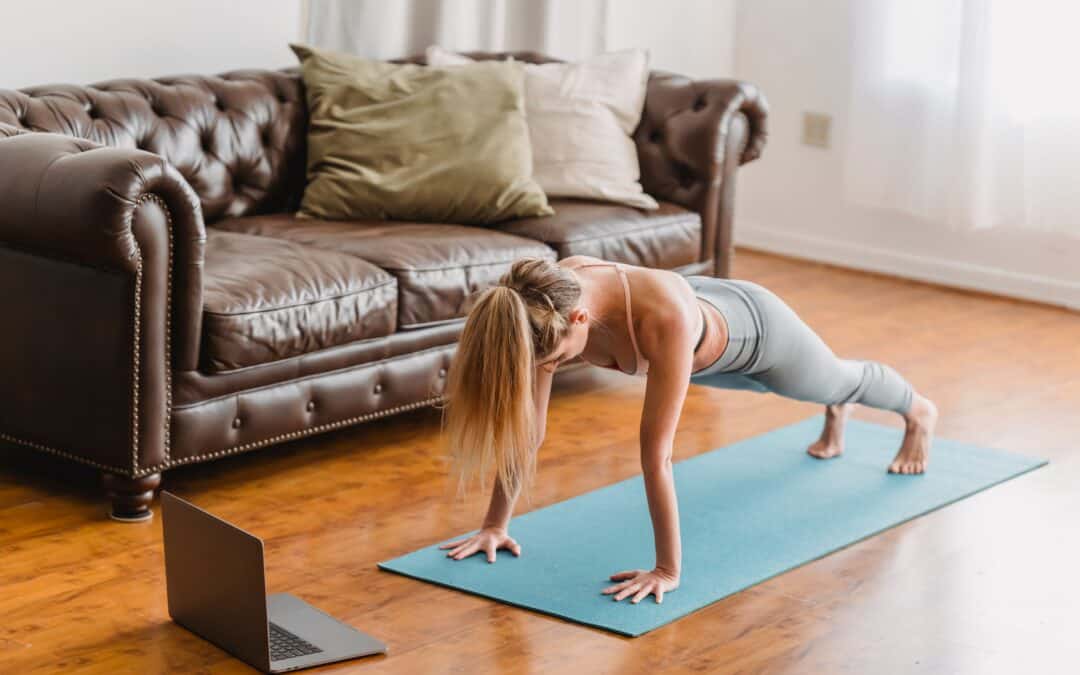 woman working out at home through online coaching.