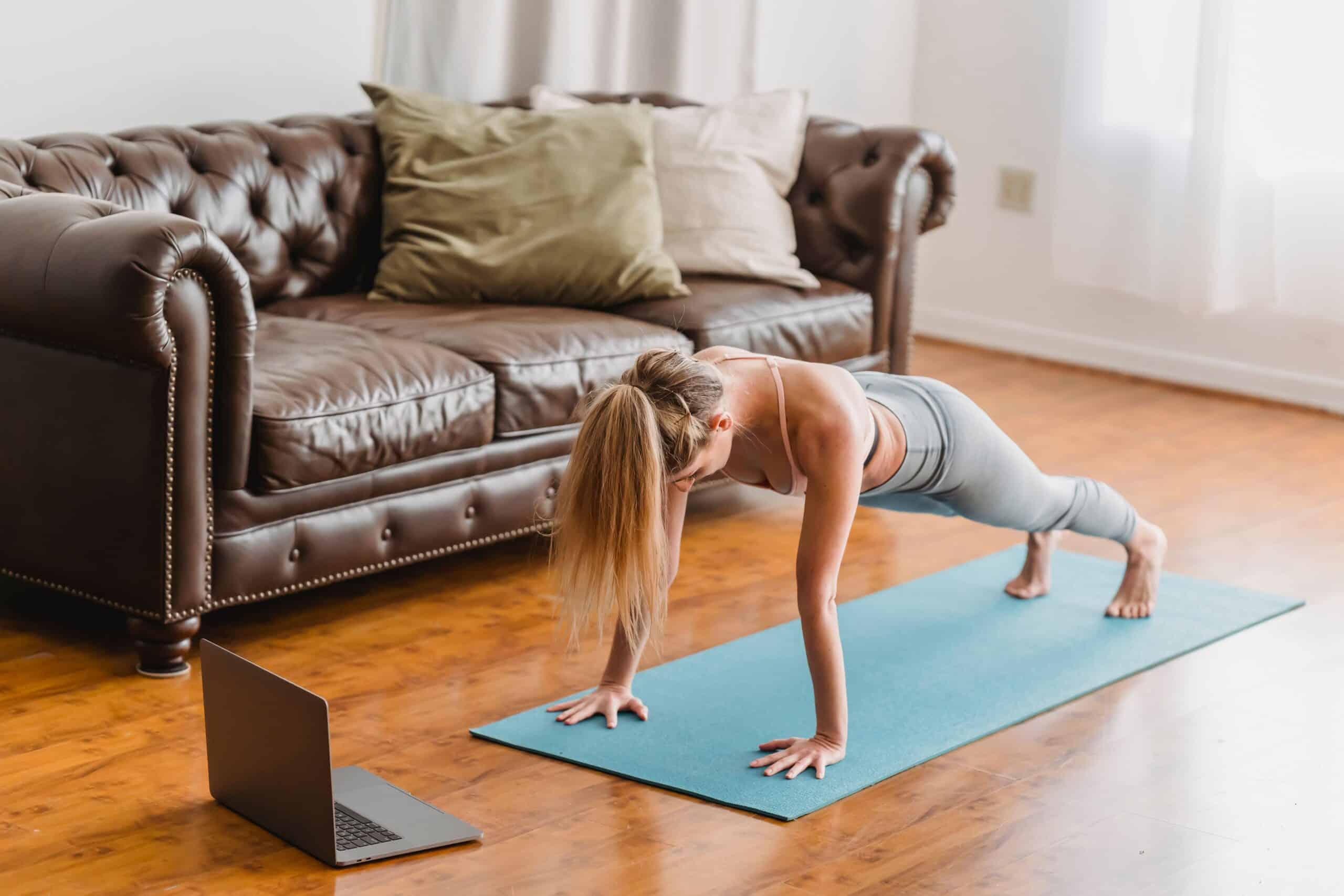 woman working out at home through online coaching.